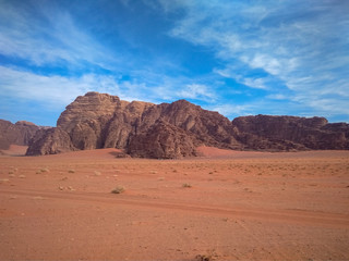 Fototapeta na wymiar rock formations and desert landscape of Wadi Rum desert in southern Jordan. Popular tourist destination and place of Lawrence of Arabia