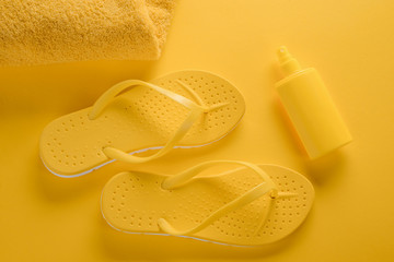 Towel, flip-flops and sunscreen spray