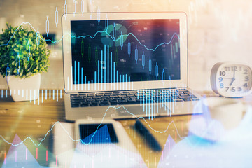 Financial chart drawing and table with computer on background. Double exposure. Concept of international markets.