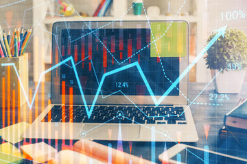 Financial graph colorful drawing and table with computer on background. Double exposure. Concept of international markets.
