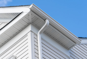 Colonial white fiber cement horizontal vinyl lap siding, soffit with ventilation,  gutter and...