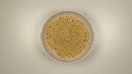 TOP VIEW: Ginger powder in a white dish