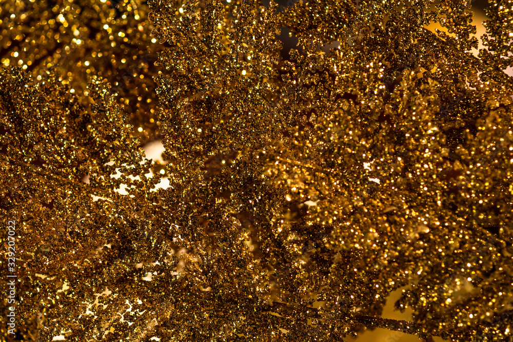 Poster a close-up shot showing the surface of a golden glittering leaf. use for background images that requ