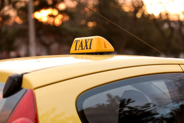 Modern taxi car on city road, closeup