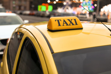 Modern taxi car on city road, closeup