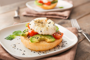 Sandwich with poached egg on plate, closeup