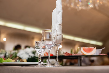 Elegant dinner table setting in restaurant or hotel with wine glasses. Luxurious elegant dinner at the table. Holiday table decoration