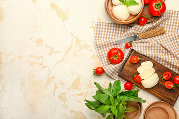 Mozzarella cheese with tomatoes and basil on white background