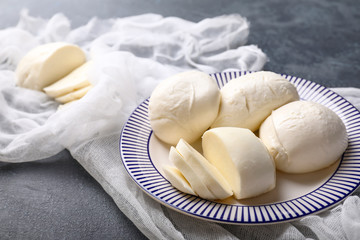 Plate with mozzarella cheese on dark background