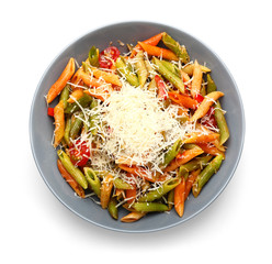 Plate with tasty pasta and cheese on white background