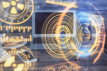 Fototapeta premium Computer on desktop in office with technology theme hologram. Multi exposure. Tech concept.