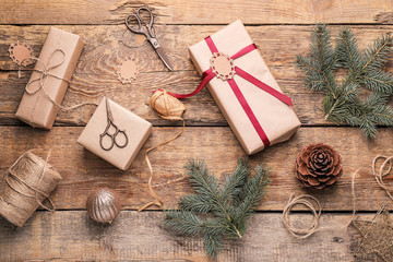 Beautiful gifts for Christmas with decor on wooden background