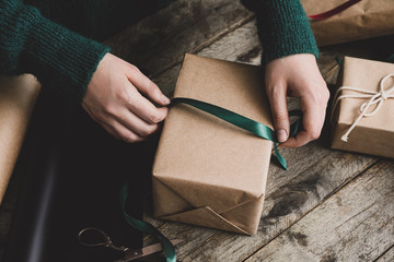 Woman making beautiful Christmas gift at table