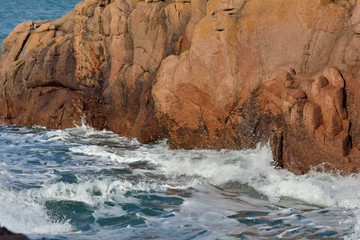 Waves on the rocks pink granite coast in Brittany. France