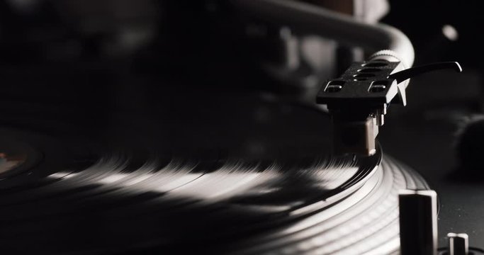 Closeup of a Vinyl Recod Player beeing started, Needle positioned and lowered