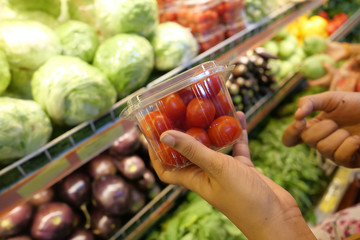 Close up of women hand shopping vegetables 