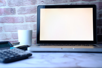 laptop with white screen on office table 