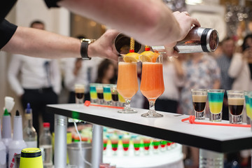 Horizontal images of bartender prepares a yellow cocktail in the nightclub. Party and holiday celebration concept