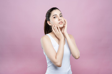 Mix asian caucasian woman confident beauty poses for healthy skin beauty in pink seamless background. Cosmetic, skincare, surgery concept. Her skin and face are beautiful, fresh and youthful.