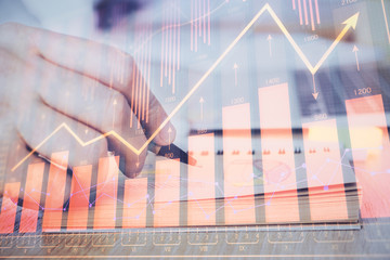 Multi exposure closeup hands with stock market forex graph.