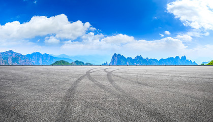 Empty race track road and green mountain with beautiful clouds,panoramic view.