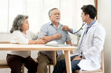 Fototapeta premium Asian elderly couples are sick doctor to check their symptoms at home. Health care , life style, pharmacy, medical, elder insurance after retire concept.