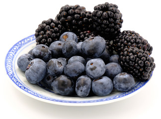 Blueberry and Blackberry on blown cup with white background, fruit concept