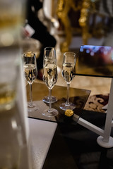 Closeup of many glasses of fresh champagne on bar table. Party and holiday celebration concept