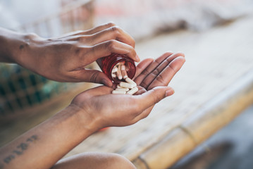 Pills and medicine in woman hands, Hazardous drugs have adverse effects on health.