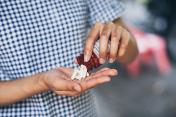 Pills and medicine in woman hands, Hazardous drugs have adverse effects on health.