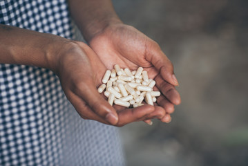 Pills and medicine in woman hands, Hazardous drugs have adverse effects on health.