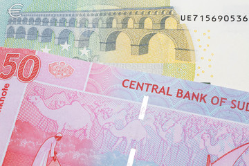 A five Euro, European Union bill with a fifty pound note from Sudan close up in macro