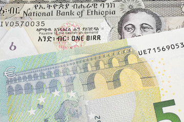 A one birr note from Ethiopia in macro with a five Euro European bank note close up