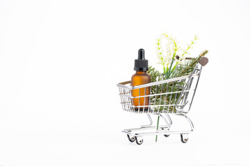 Natural  cosmetics concept: Cosmetics with leaves on shopping cart