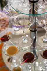 Festive table with cold exotic alcoholic beverages, cocktails. Party and holiday celebration concept