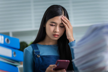 Young woman got tired of working with stack of papers financial reports accountant and tax service.