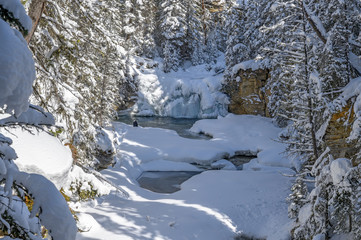 Fototapeta na wymiar Winter view of a frozen waterfall at Johnston Canyon in Banff National Park, Alberta, Canada