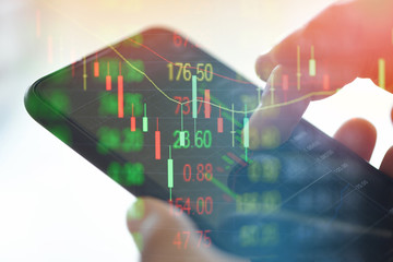 Trading stock graph or forex online with application on smartphone - Businessman trading stocks...