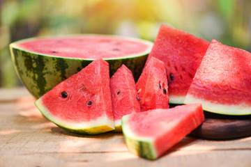 Sliced watermelon on wooden and nature background - Close up fresh watermelon pieces tropical summer fruit