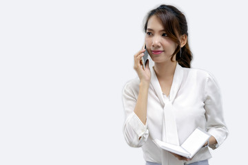 Business women calling and holding a notebook in white background