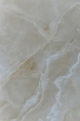 Natural beige polished marble with lines similar to the mountainside.