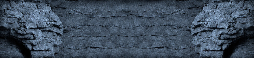 Dark gray blue grunge background. The texture of the old stone wall. Rough cracked stone surface. Black grunge banner with copy space.