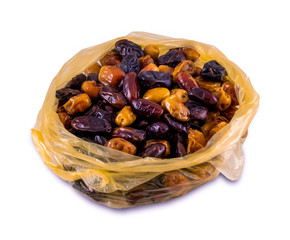 Dried dates in a shopping bag, isolated on white background. Date fruits with different varieties.