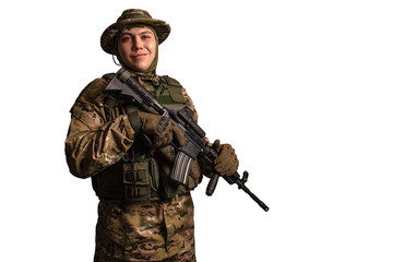 Fototapeta premium Portrait of soldier in military camouflage uniform protected with helmet, body armour, holding machine gun desaturated on a white background .
