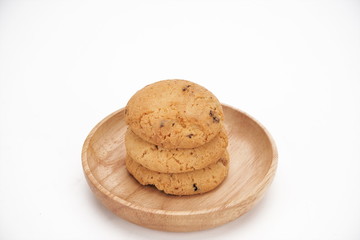 Cookies on a white ceramic plate on the gray kitchen table. Top view with copy space.Chocolate chip cookies isolated on a white background. Cookies homemade cakes.