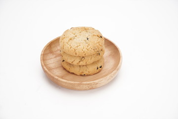 Cookies on a white ceramic plate on the gray kitchen table. Top view with copy space.Chocolate chip cookies isolated on a white background. Cookies homemade cakes.