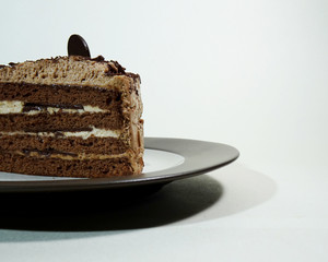 Delicious chocolate sponge cake layered with chocolate cream and finished with chocolate flakes and...