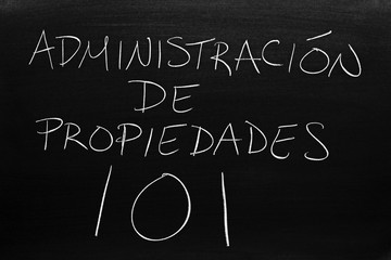 The words Administración De Propiedades 101 on a blackboard in chalk.  Translation: Property Mangement 101