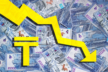 Laid out on the surface of 20,000 tenge banknotes with a tenge symbol and a down arrow. Devaluation of tenge concept