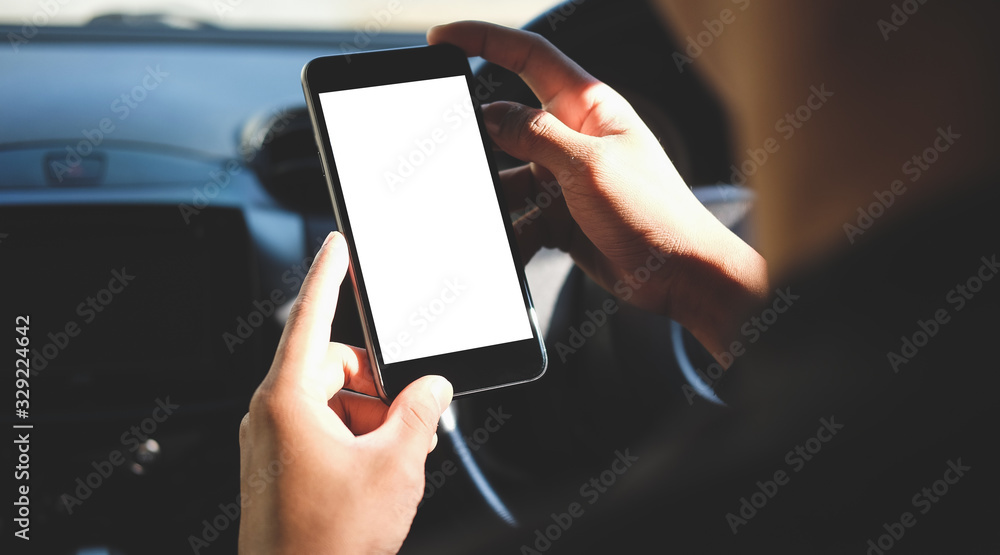 Poster cropped shot view the driver uses the phone while driving. modern smart phone with round edges. isol